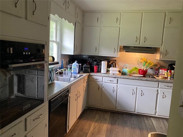 kitchen with dark wood-type flooring, sink, decorative backsplash, black appliances, and white cabinetry