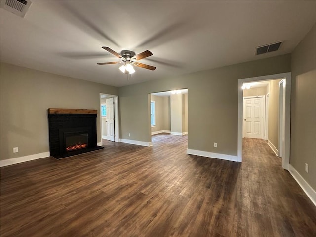 8245 Pleasant Grove Cir, Gainesville, GA 30506 - unfurnished living room with dark wood-style flooring, a ceiling fan, a lit fireplace, and baseboards
