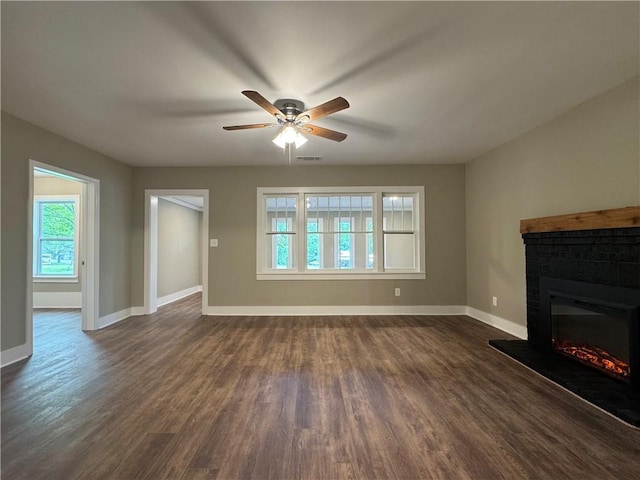 8245 Pleasant Grove Cir, Gainesville, GA 30506 - unfurnished living room with a brick fireplace, healthy amount of natural light, and dark wood-style flooring