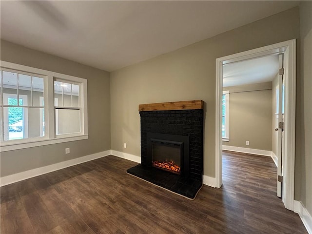 8245 Pleasant Grove Cir, Gainesville, GA 30506 - unfurnished living room featuring a fireplace, dark wood-style flooring, and baseboards