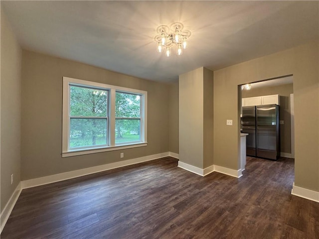 8245 Pleasant Grove Cir, Gainesville, GA 30506 - spare room featuring dark wood-style flooring, a chandelier, and baseboards