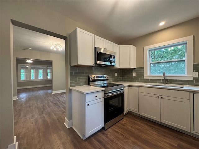 8245 Pleasant Grove Cir, Gainesville, GA 30506 - kitchen featuring appliances with stainless steel finishes, a sink, dark wood-style floors, light countertops, and decorative backsplash