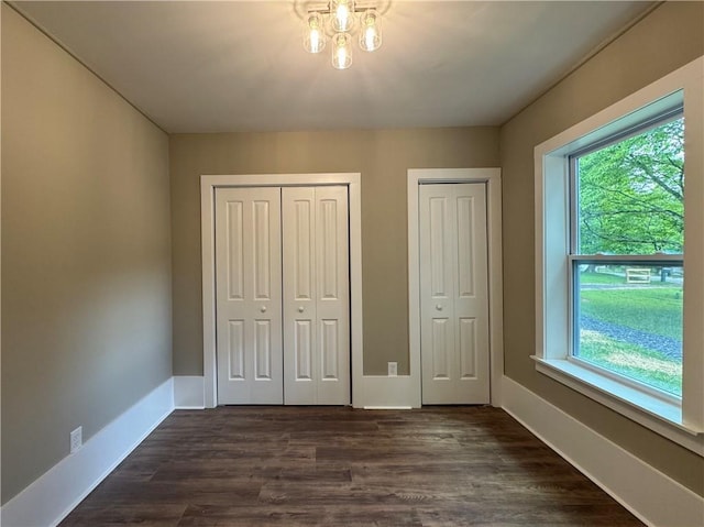 8245 Pleasant Grove Cir, Gainesville, GA 30506 - unfurnished bedroom with multiple windows, two closets, and baseboards