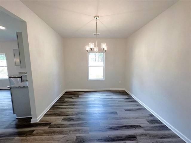 unfurnished dining area with dark wood-style floors, plenty of natural light, and baseboards