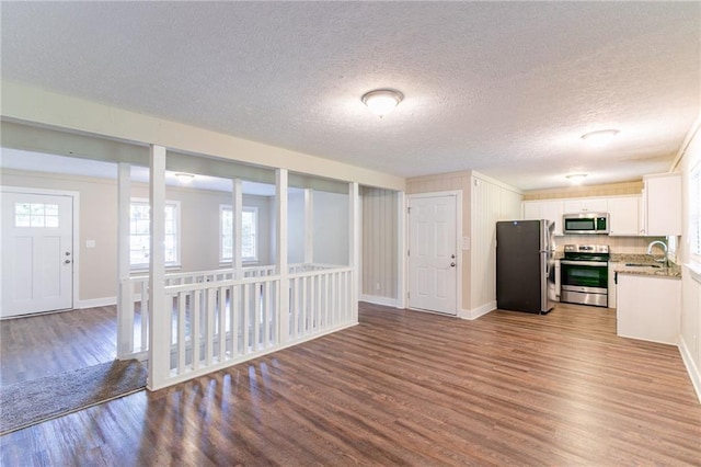 kitchen featuring sink, stainless steel appliances, light hardwood / wood-style flooring, and white cabinets