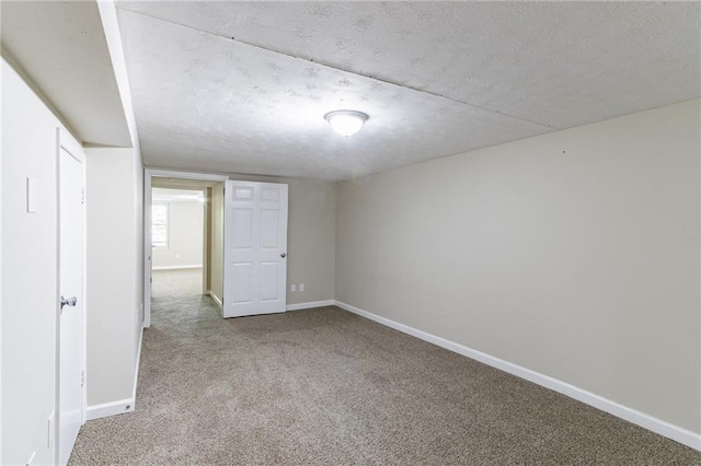 interior space with a textured ceiling and light colored carpet