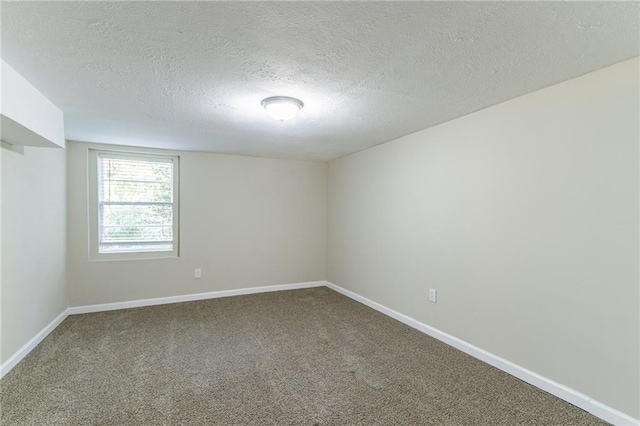 carpeted spare room with a textured ceiling