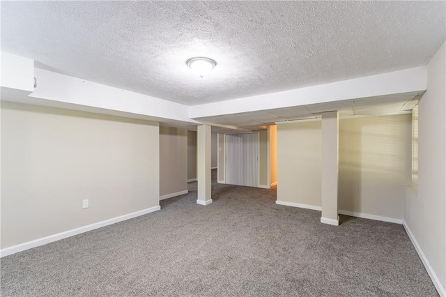 basement with carpet flooring and a textured ceiling