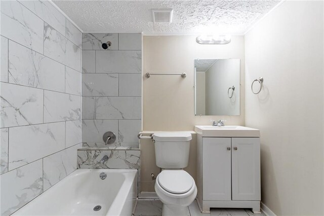 full bathroom featuring vanity, tiled shower / bath combo, a textured ceiling, and toilet