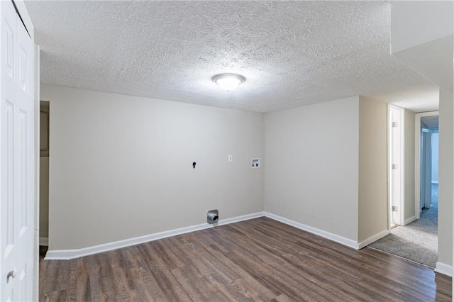 washroom with washer hookup, a textured ceiling, and dark wood-type flooring