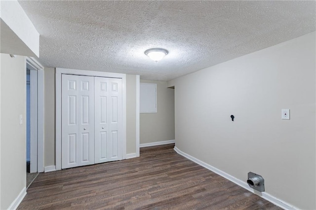 unfurnished bedroom featuring a closet, a textured ceiling, and dark hardwood / wood-style floors