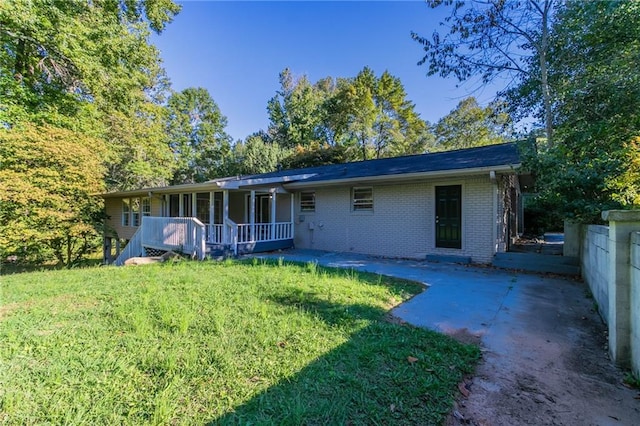 rear view of house featuring a yard and a patio area