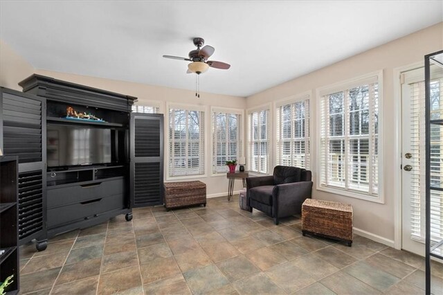 sitting room featuring baseboards and ceiling fan