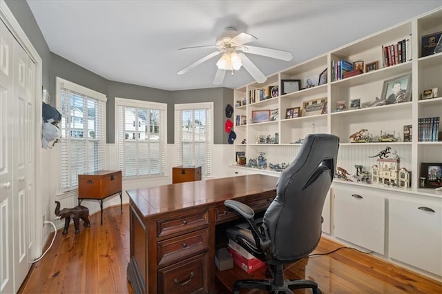 office space with light wood-type flooring and a ceiling fan