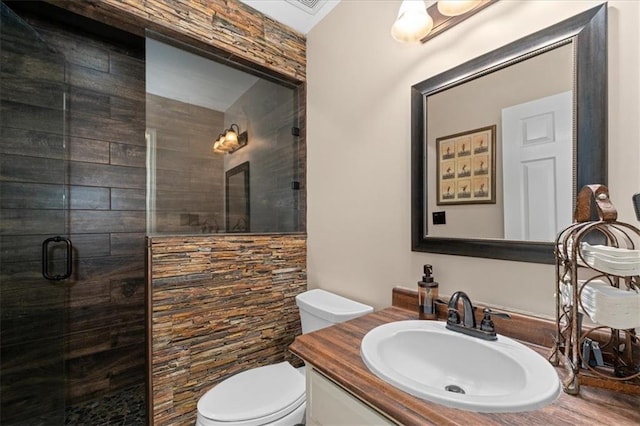 full bath featuring vanity, a shower stall, and toilet