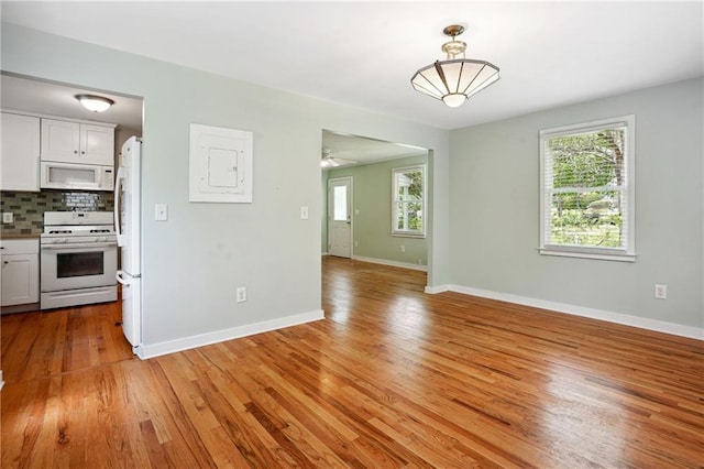 1891 8th St, Atlanta, GA 30341 - kitchen with white appliances, plenty of natural light, and light wood finished floors