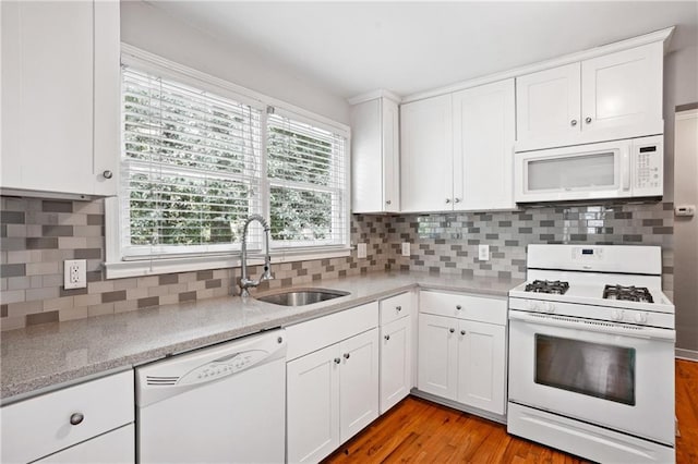 1891 8th St, Atlanta, GA 30341 - kitchen with white appliances, a sink, white cabinetry, decorative backsplash, and light wood-style flooring