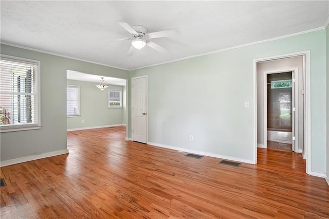 1891 8th St, Atlanta, GA 30341 - spare room featuring crown molding, light wood-type flooring, ceiling fan, baseboards, and a chandelier