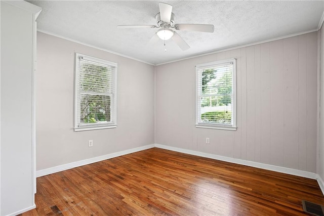 1891 8th St, Atlanta, GA 30341 - spare room featuring plenty of natural light, wood-type flooring, ceiling fan, ornamental molding, and a textured ceiling