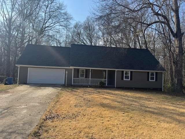 ranch-style house with a garage and a porch