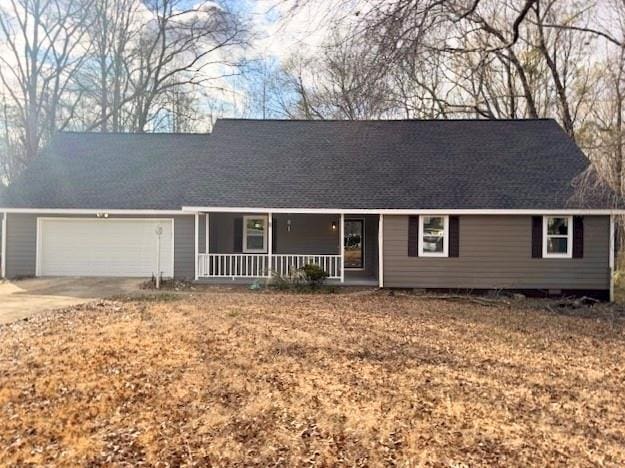 single story home with a porch, roof with shingles, driveway, and a garage