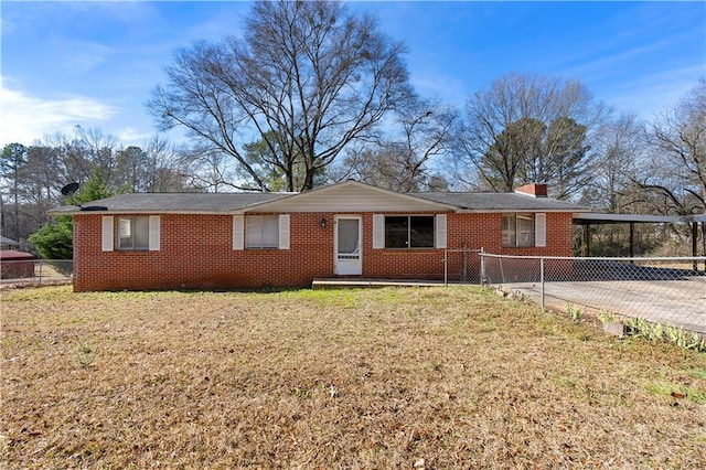 ranch-style home with a carport and a front yard