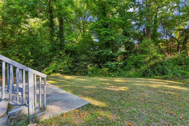 rear view of property featuring central AC unit and a yard