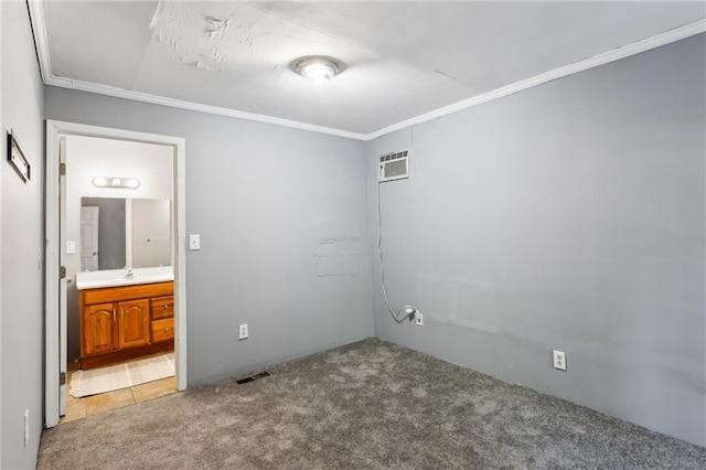 carpeted empty room featuring ornamental molding and a wall mounted air conditioner