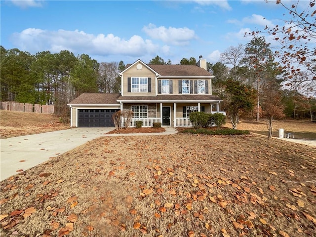 colonial home with covered porch and a garage