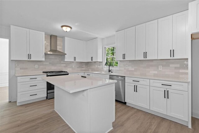 4166 Riverhill Ct NE, Roswell, GA 30075 - kitchen featuring wall chimney exhaust hood, appliances with stainless steel finishes, light wood-style floors, light countertops, and decorative backsplash