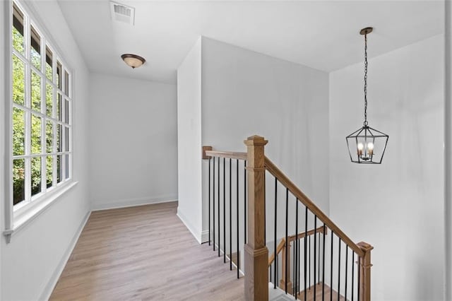 4166 Riverhill Ct NE, Roswell, GA 30075 - hallway featuring a chandelier, an upstairs landing, and wood finished floors