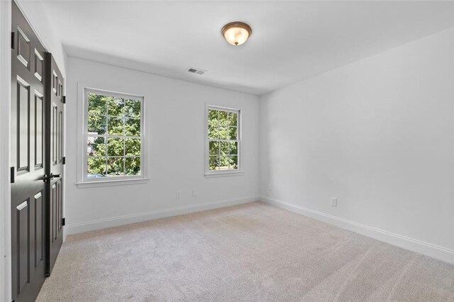 4166 Riverhill Ct NE, Roswell, GA 30075 - unfurnished room featuring plenty of natural light, light carpet, and baseboards