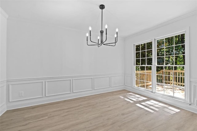 4166 Riverhill Ct NE, Roswell, GA 30075 - unfurnished dining area featuring a chandelier, ornamental molding, wood finished floors, a decorative wall, and a wainscoted wall
