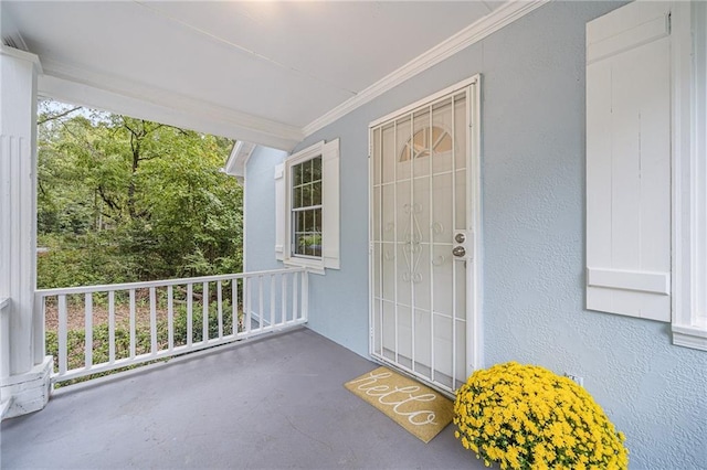 view of exterior entry featuring covered porch