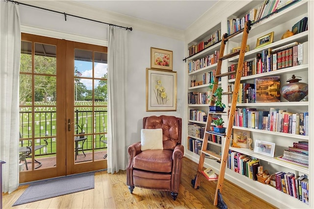 351 NE Washington Ave NE Unit 307, Marietta, GA 30060 - sitting room featuring crown molding, french doors, wood finished floors, and bookshelves