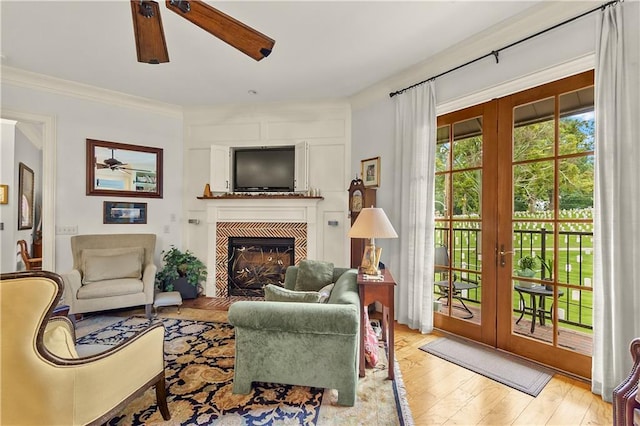 351 NE Washington Ave NE Unit 307, Marietta, GA 30060 - living room featuring a ceiling fan, french doors, wood finished floors, and a tiled fireplace