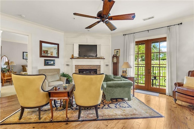 351 NE Washington Ave NE Unit 307, Marietta, GA 30060 - living area with a ceiling fan, a glass covered fireplace, hardwood / wood-style floors, and crown molding