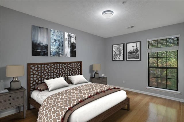 bedroom with wood-type flooring