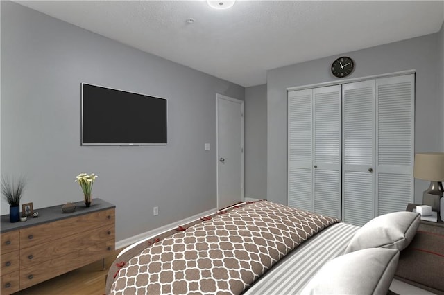 bedroom with hardwood / wood-style flooring and a closet