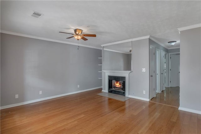 unfurnished living room featuring ornamental molding, light hardwood / wood-style floors, and ceiling fan