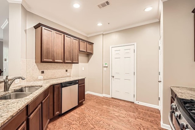 kitchen with light stone counters, sink, stainless steel appliances, and crown molding