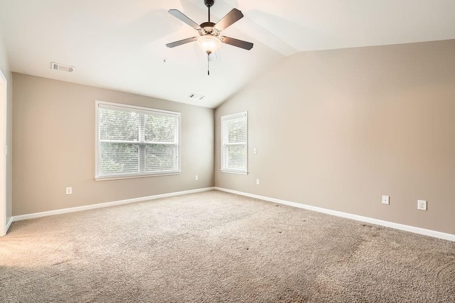 spare room with carpet, ceiling fan, and vaulted ceiling