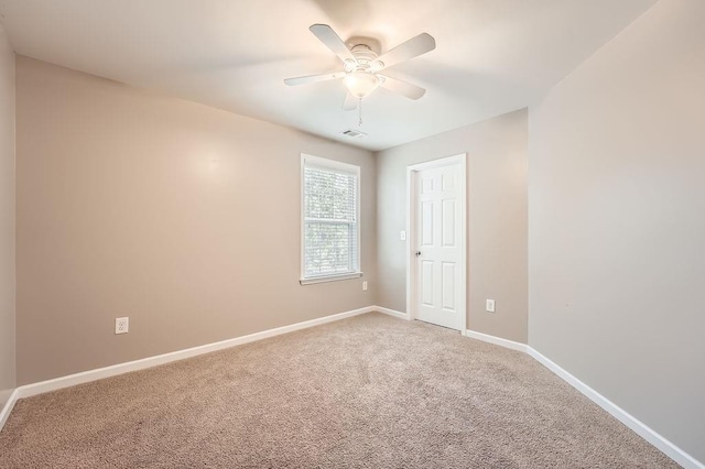 carpeted spare room with ceiling fan