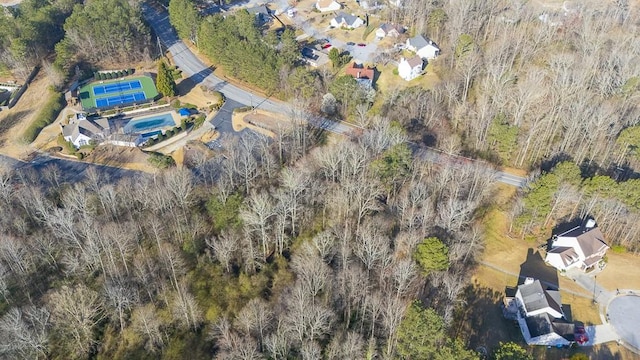 birds eye view of property featuring a wooded view