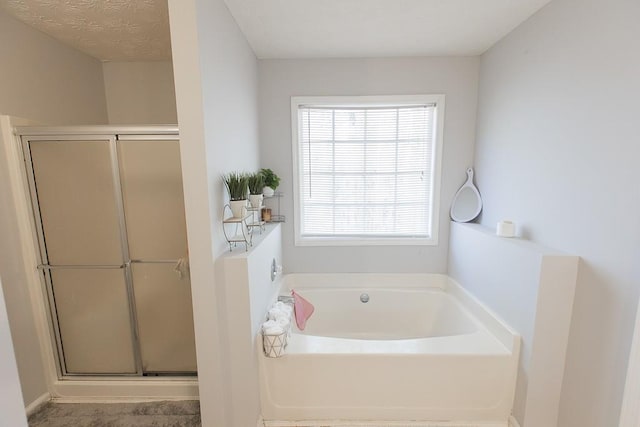 full bath featuring a shower stall and a bath