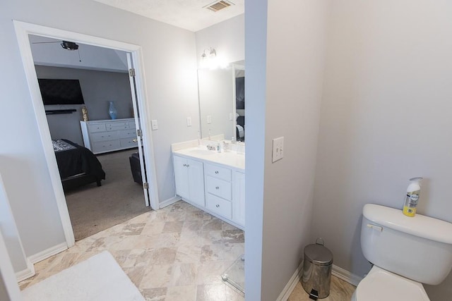 ensuite bathroom featuring visible vents, toilet, connected bathroom, baseboards, and vanity