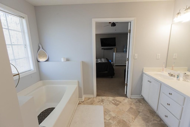 bathroom featuring baseboards, connected bathroom, vanity, and a garden tub