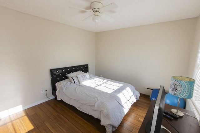 bedroom with baseboards, ceiling fan, and wood-type flooring