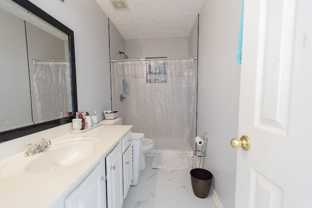 bathroom featuring vanity, visible vents, a textured ceiling, toilet, and marble finish floor