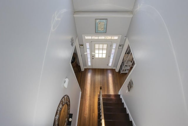 entrance foyer with hardwood / wood-style floors, stairway, and baseboards